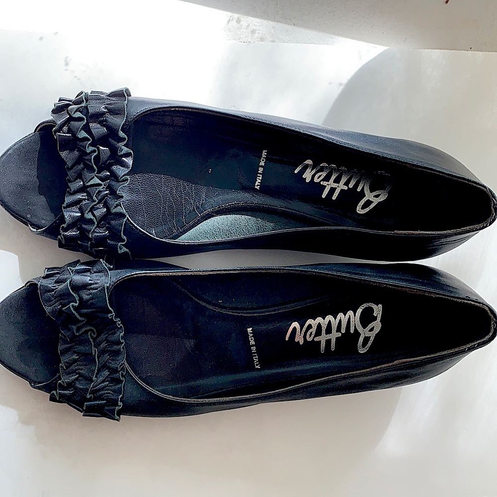 Black leather low wedge slip on by Butter size 8.5